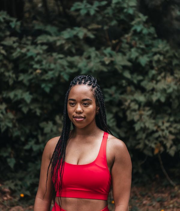 A fit woman in activewear smiling and feeling energetic.