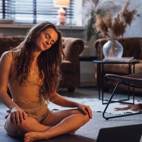 Person practicing a gentle balancing exercise in a calm environment.